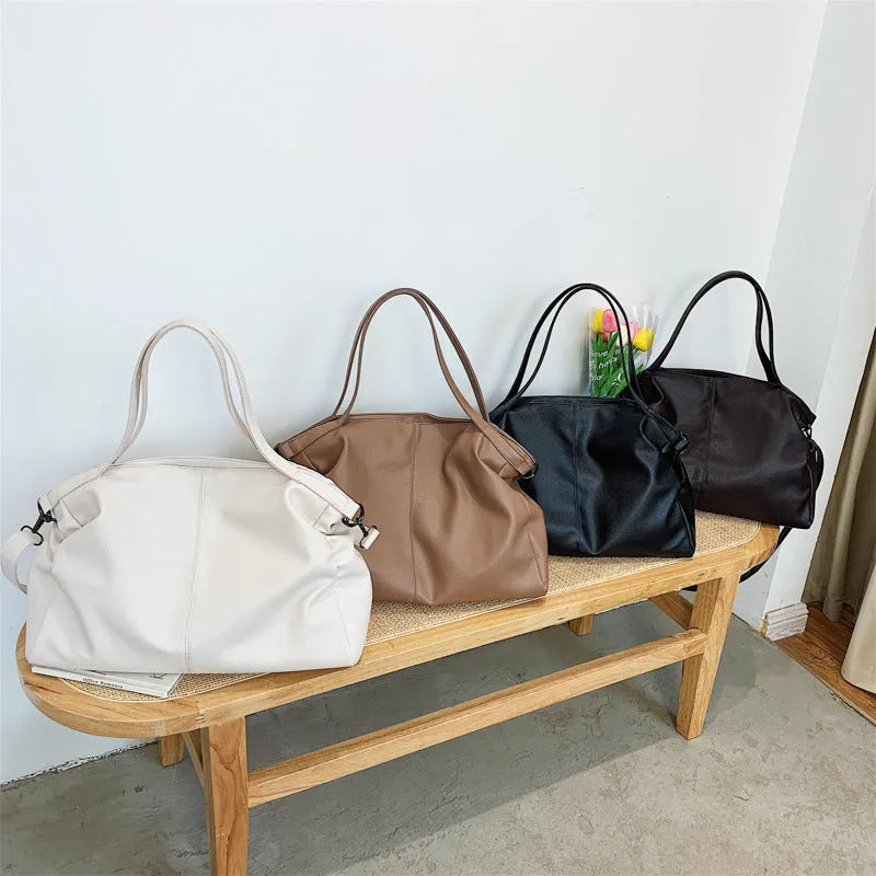 Large soft surface messenger bag in black with adjustable shoulder strap and zip opening