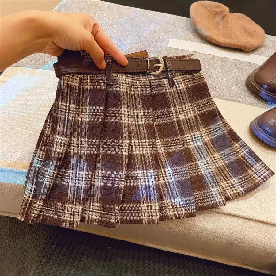 Girls' red and black plaid pleated A-line skirt with a cotton blend fabric.