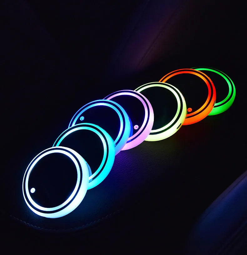 Colourful LED light-up coaster for car cup holder with solar panel and USB cable.