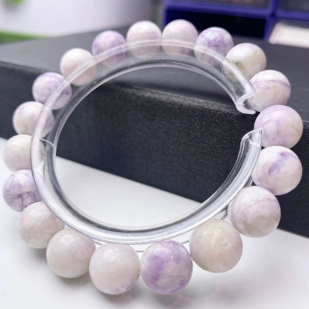 A purple turquoise bead bracelet for women showing round stone beads on a wrist.