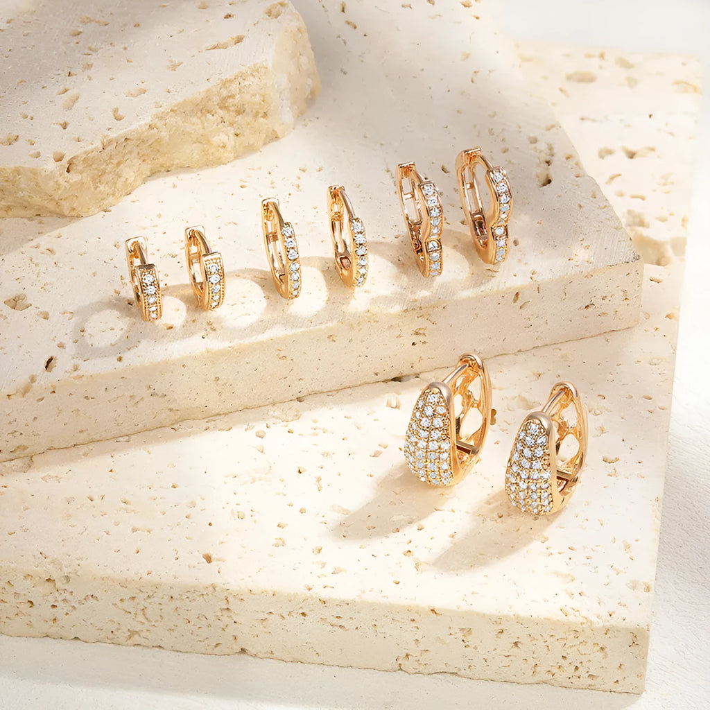 Brass gold plated heart shape clip-on earrings with gang drill detailing on a copper base.