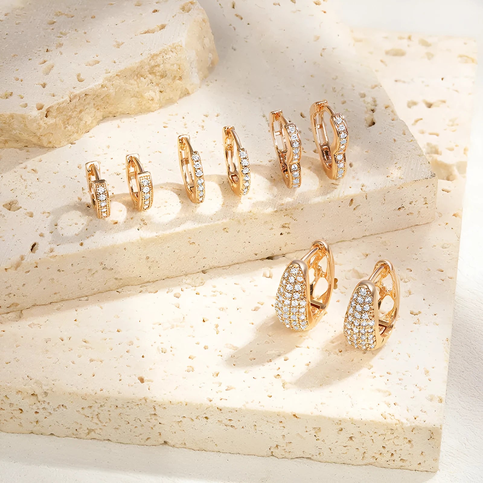 Brass gold plated heart shape clip-on earrings with gang drill detailing on a copper base.