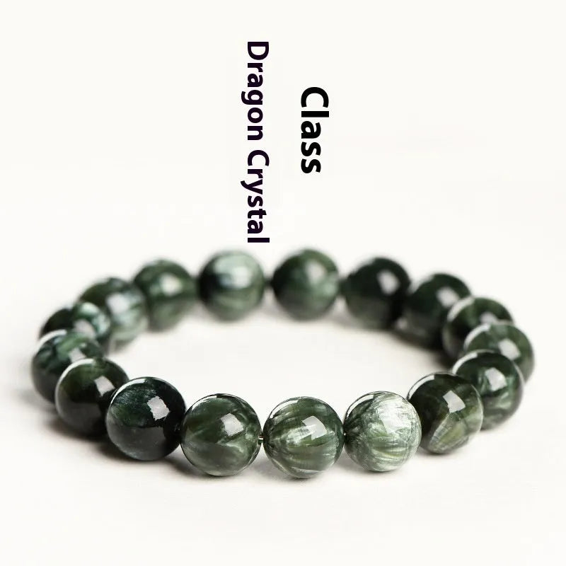 Green dragon crystal bracelet with round beads and a ruyi charm on a wrist.