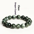 Green dragon crystal bracelet with round beads and a ruyi charm on a wrist.