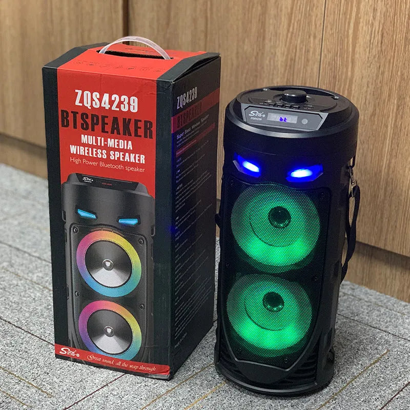 Black portable Bluetooth speaker with dual horn design and MP3 card slot on desktop