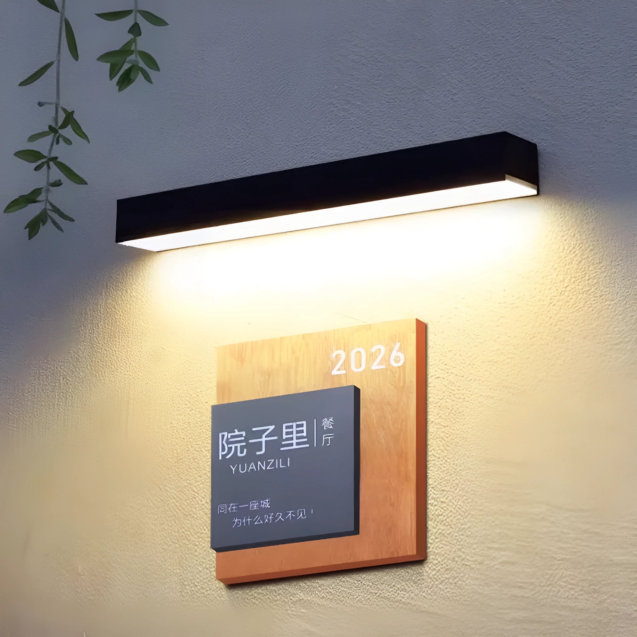 Black solar-powered outdoor wall lamp with solar strip, suitable for garden or yard.