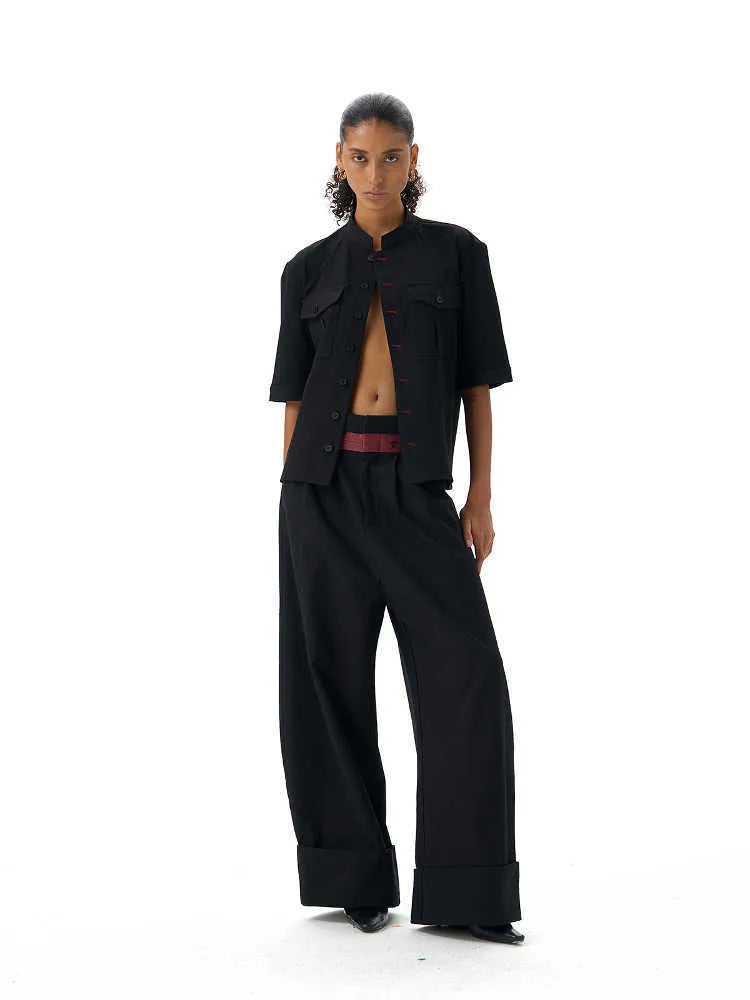 Handmade black half-sleeve shirt with a shirt collar and single-breasted front, shown in a loose fit.