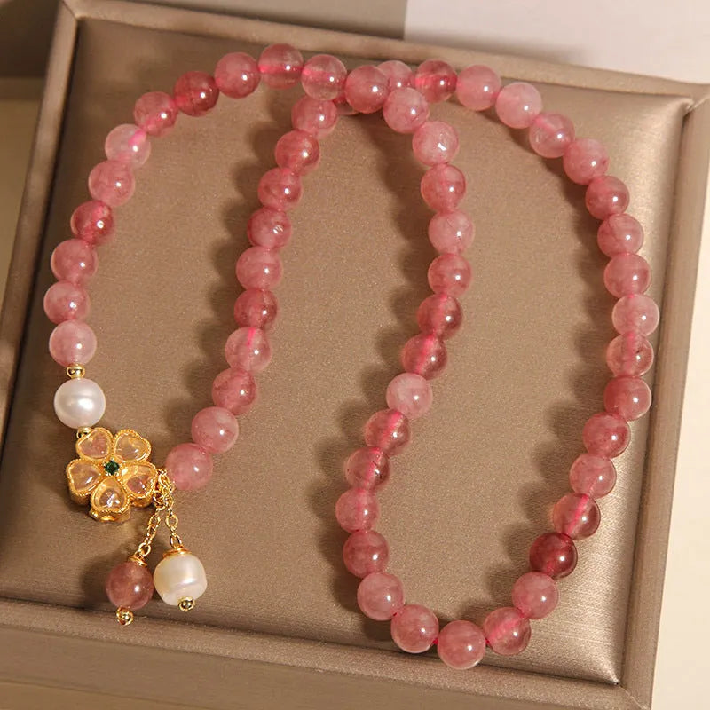 Women's twin ring bracelet with strawberry quartz four-leaf clover charms in Japanese Korean style