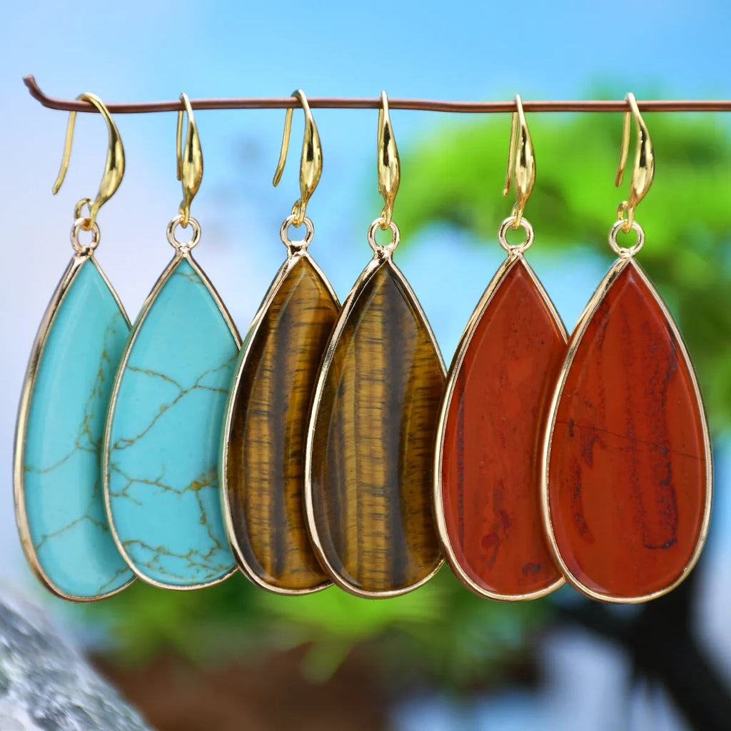 Vintage long water drop earrings in tigereye stone with textured surface and dangle silhouette