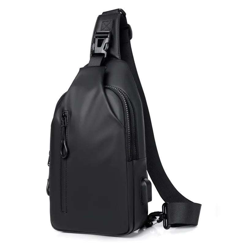 Black sling crossbody chest bag for men with zipper closure and stitched detail on a white background