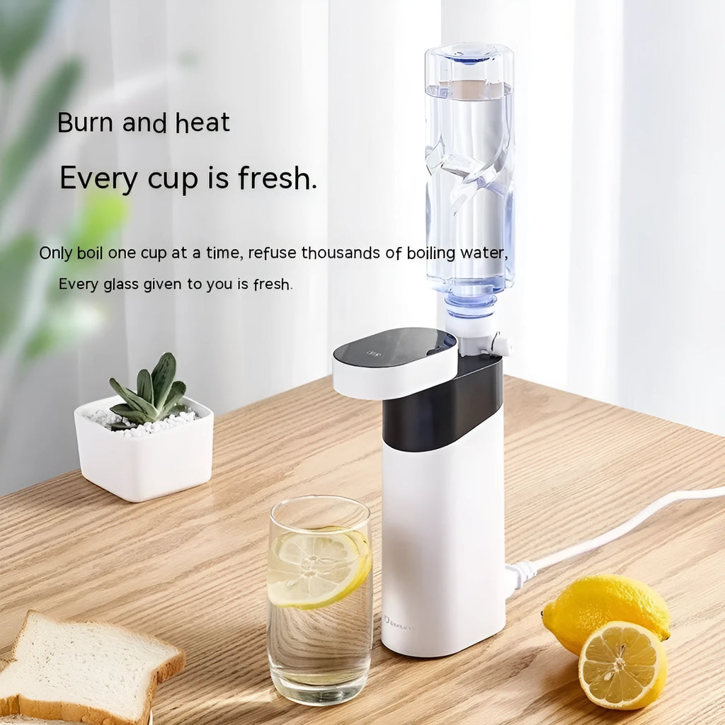 Small black or green desktop instant water dispenser with digital display and water tank.