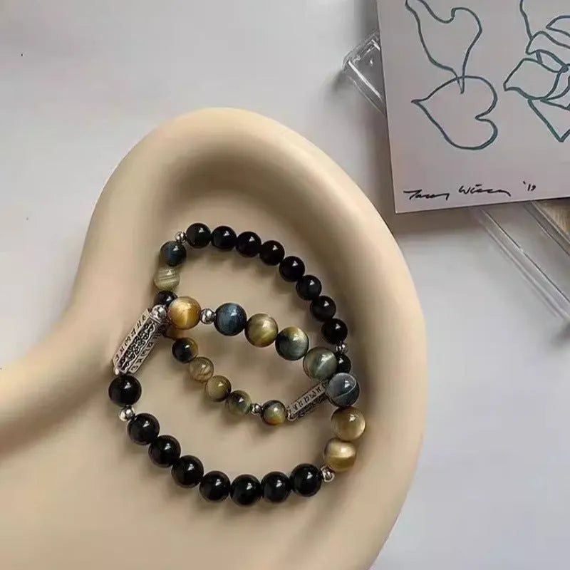 Sterling silver bracelet with obsidian and tigereye round beads featuring six words mantra Chinese design