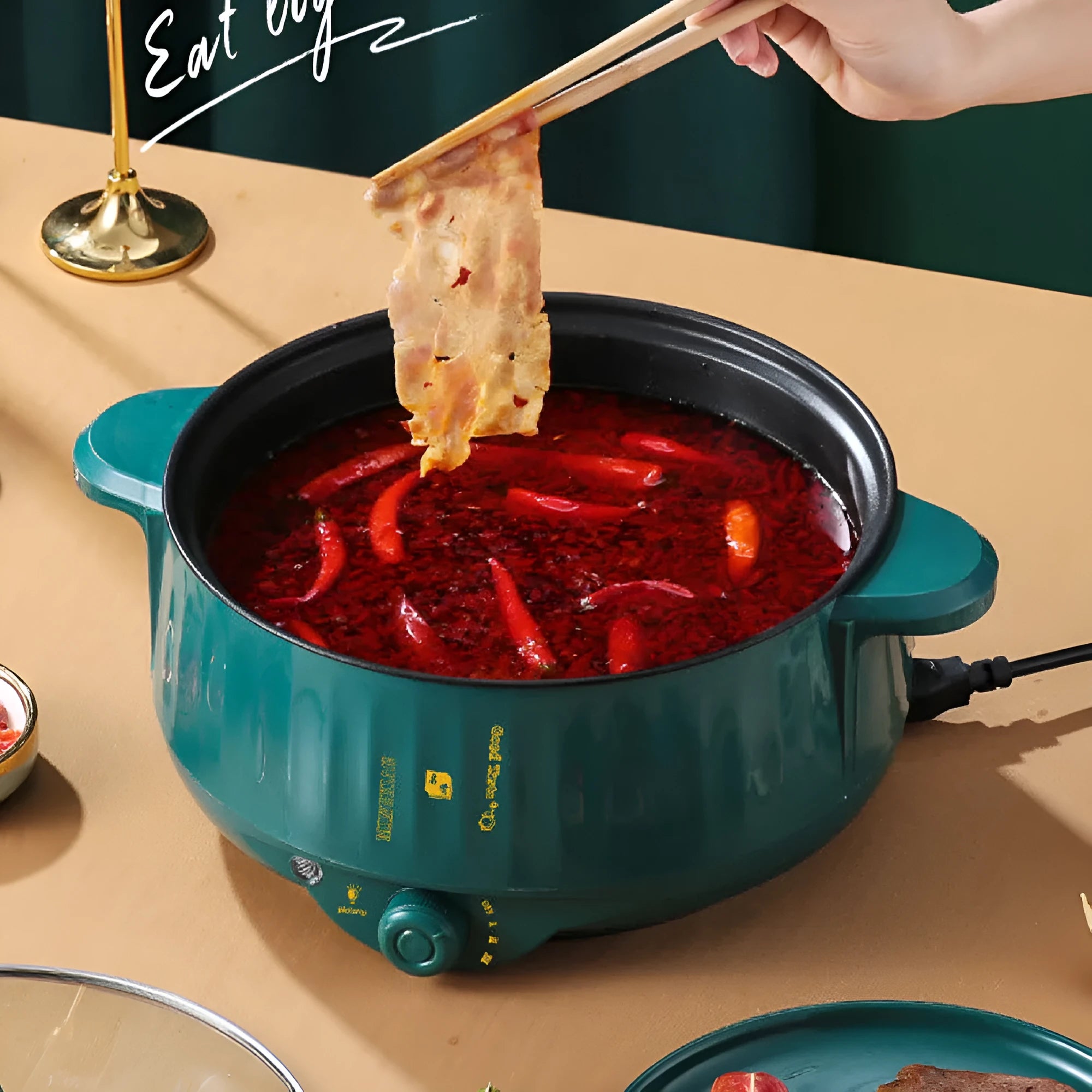 White electric hot pot with non-stick coating and stainless steel construction showing cooking functions