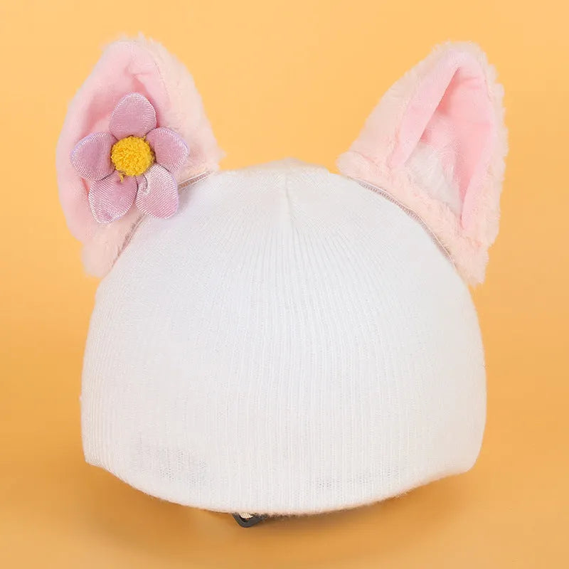 Soft plush cartoon character cover on a motorcycle helmet, showing size M and decorative ear sections.