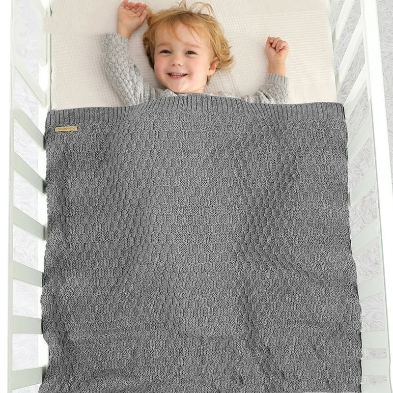 Solid colour baby hug blanket with raised line texture, shown in a light green colour.