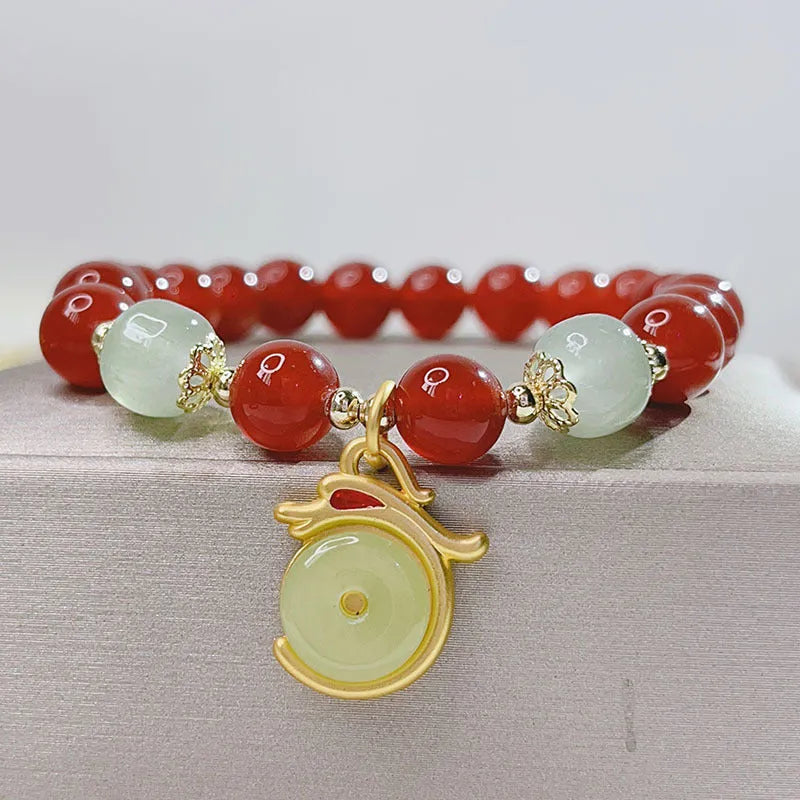 Close-up of a handmade red agate bracelet for women with a traditional Chinese dragon design.