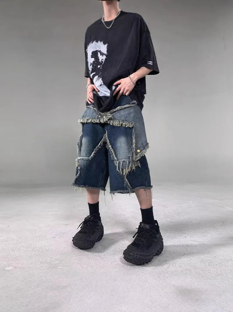 Blue men's loose-fit denim shorts with a frayed five-pointed star design on the leg.