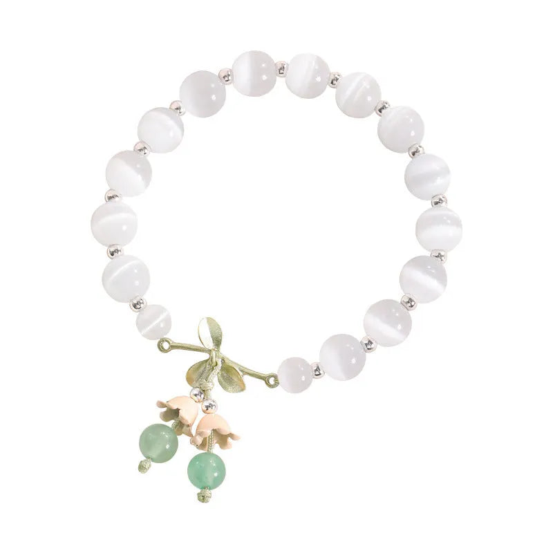 Close-up of a women's electroplated opal cat's eye stone beaded bracelet with diamond-shaped beads.