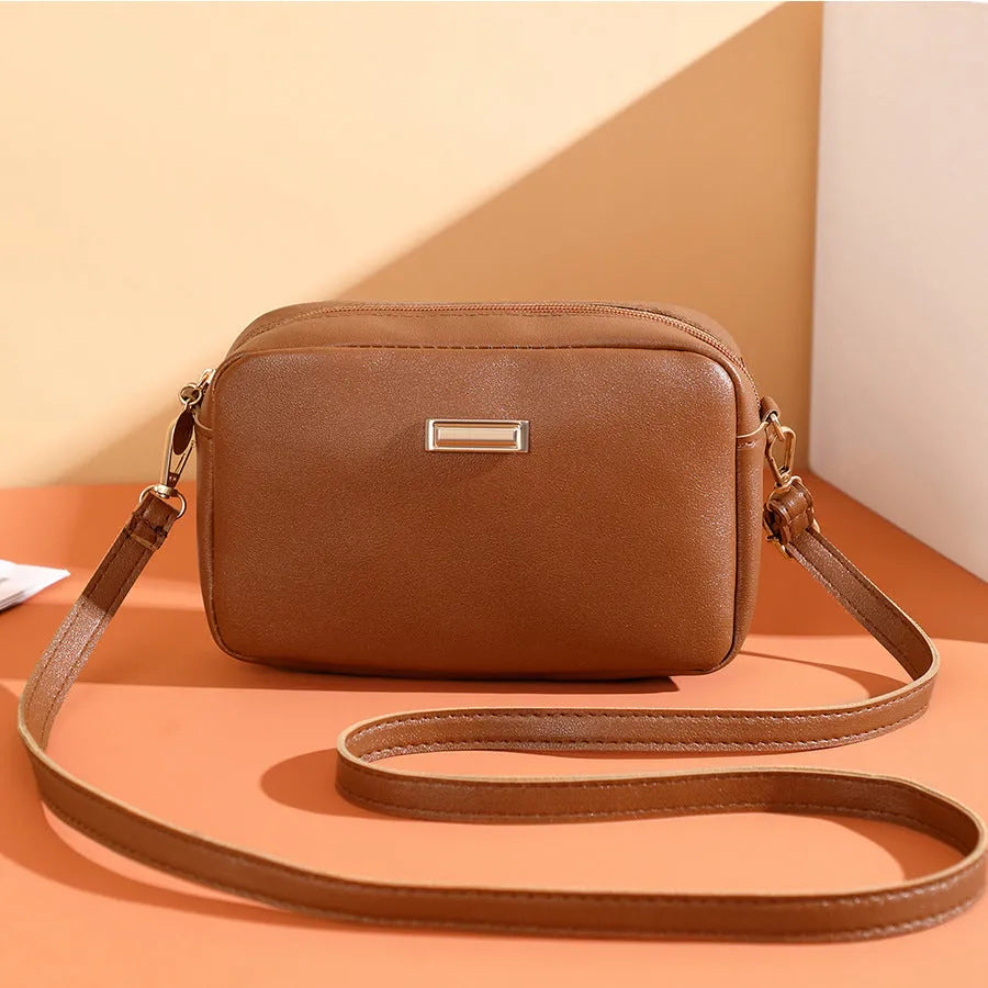 Solid colour PU ladies' shoulder bag in urban simplicity style with three-dimensional pocket.