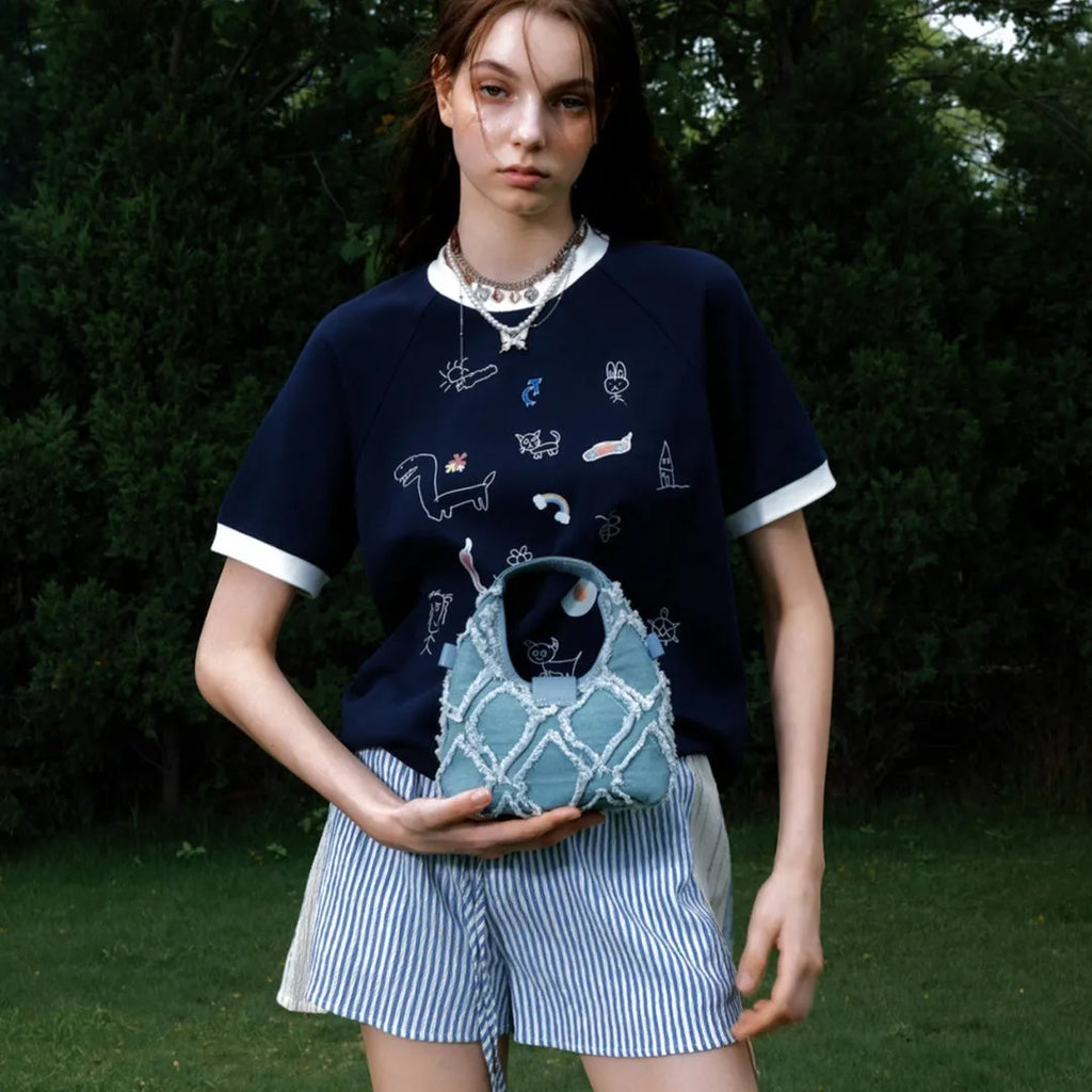 Men's blue short-sleeved shirt with cartoon print, loose fit, and contrasting colour panels.